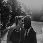 dressed up couple smiling at each other outdoors
