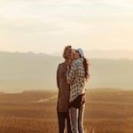 couple hiking in nature having a moment of embrace