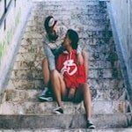 couple sitting on stairs looking at each other