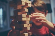 boy playing with a block tower