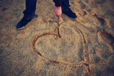 Drawing a heart in the sand