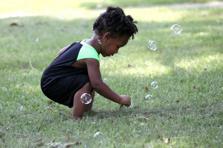 young toddler playing with bubbles