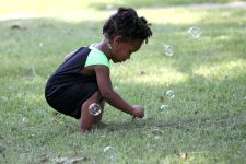 young toddler playing with bubbles